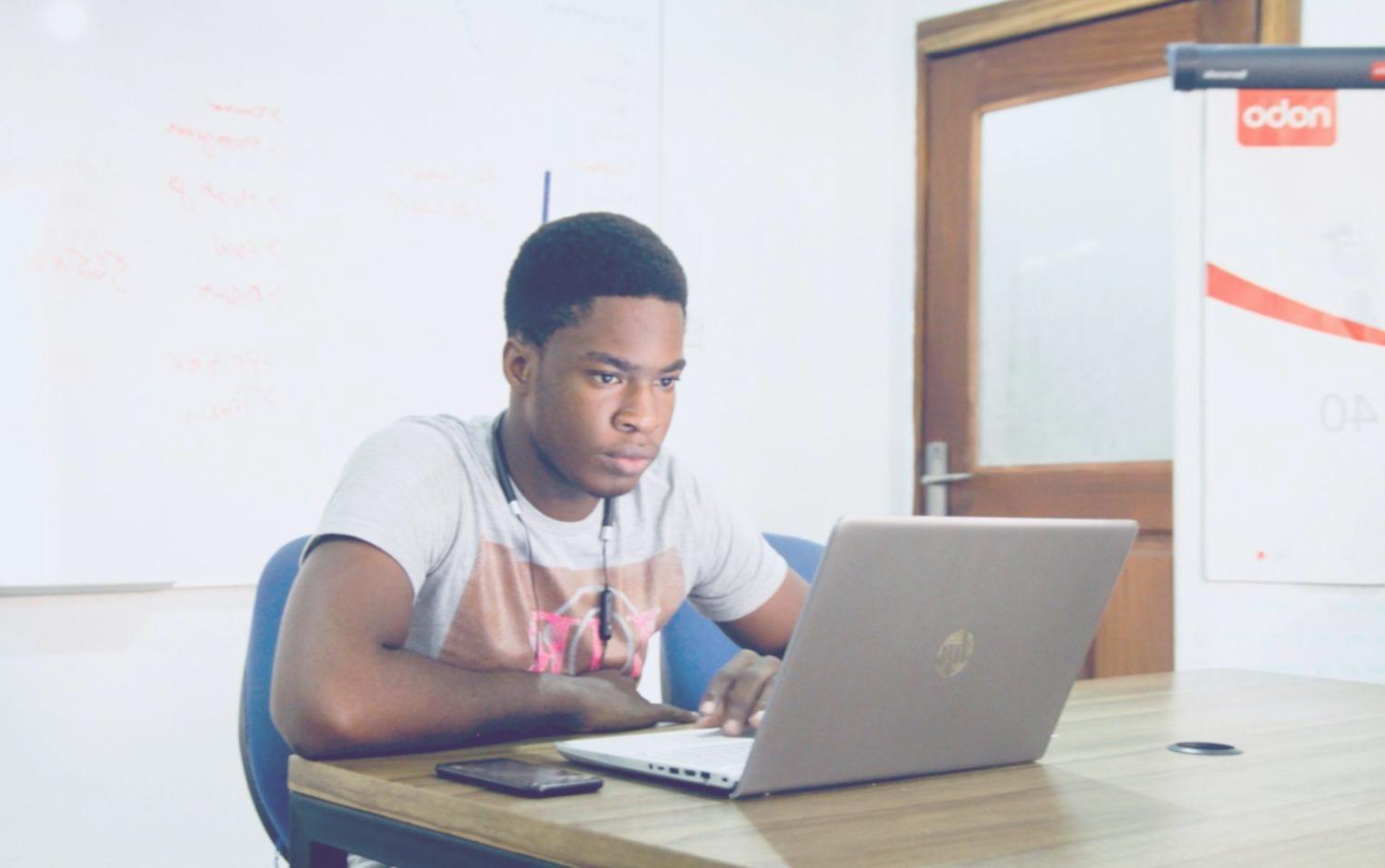 Student analyzing options trading strategies on multiple screens